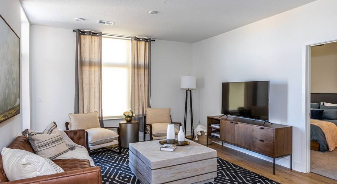 225 Sycamore sophisticated designed living room with couch, tv stand, and coffee table