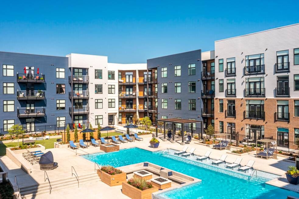 225 Sycamorre apartments view of resort style pool deck with sunken fireplace and seating